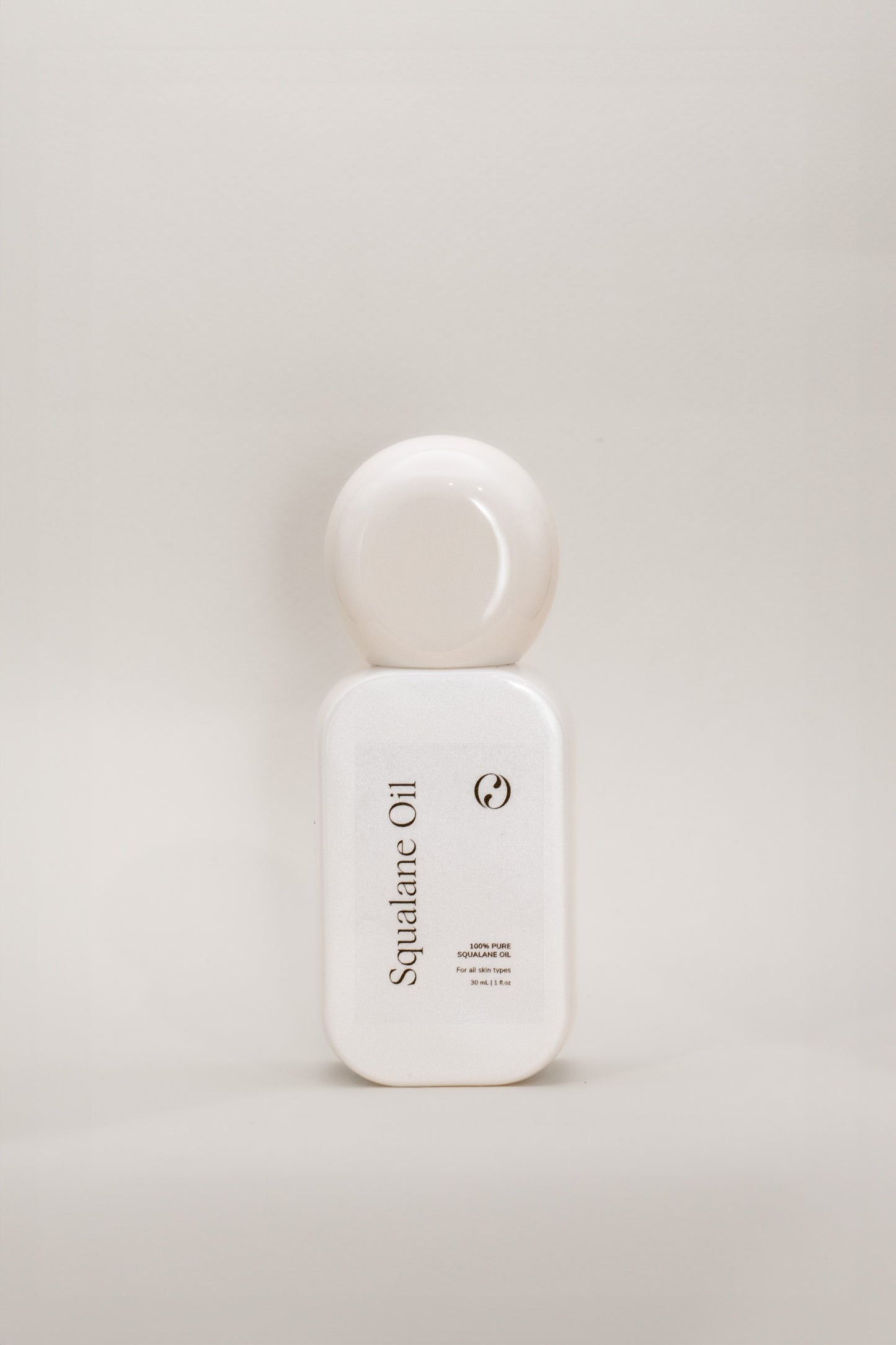 Opal Skin Studio Squalane oil bottle on beige background