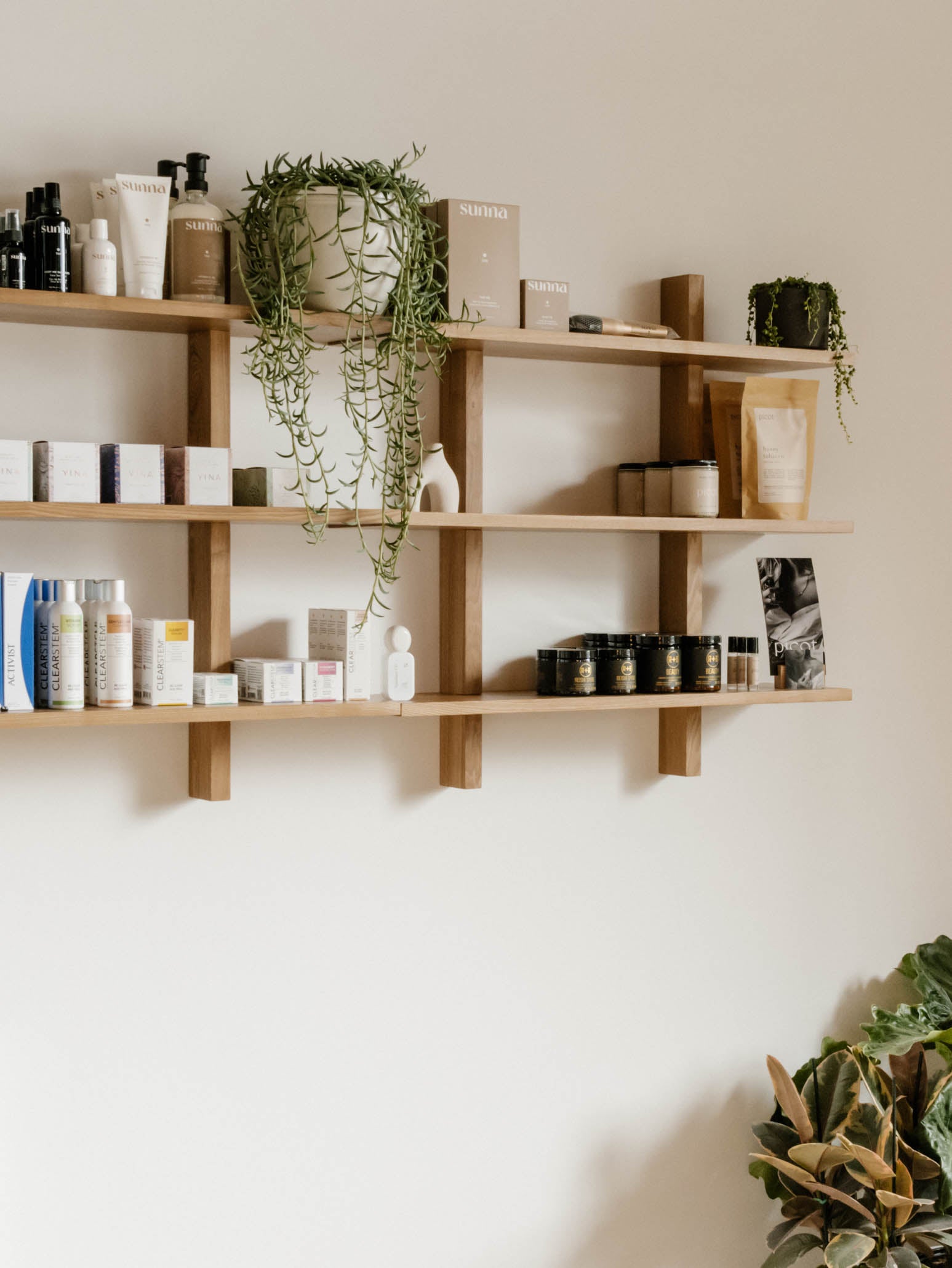 Floating shelves filled with holistic skin care and wellness products
